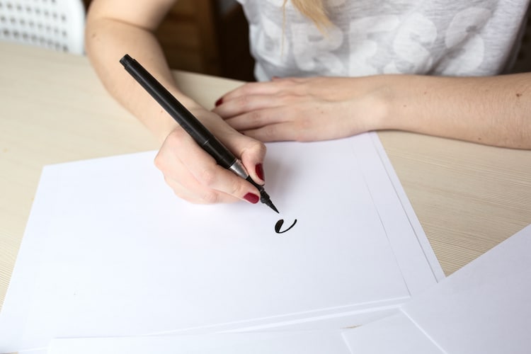 Person Drawing With a Brush Pen