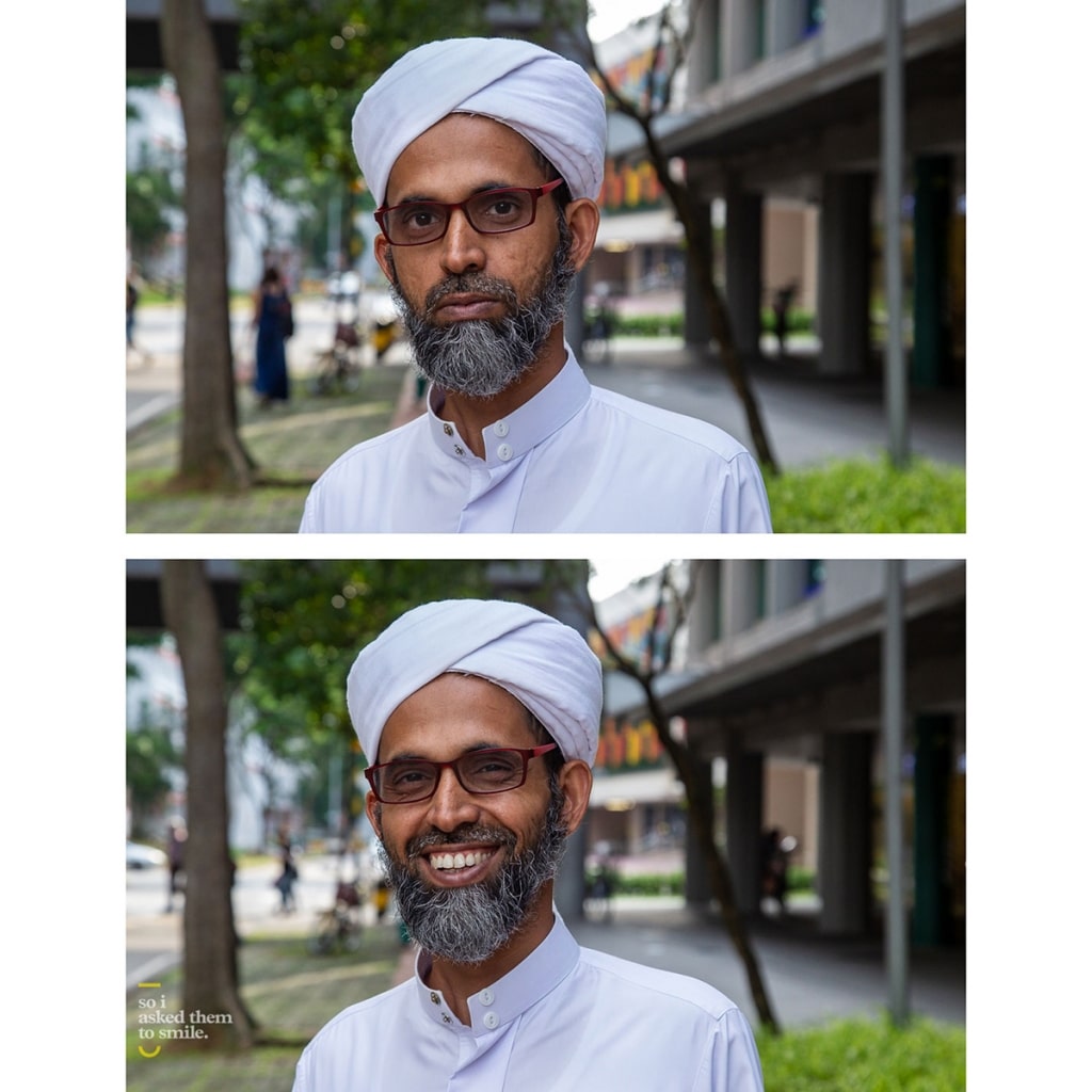 A man with glasses and a beard smiles at the camera for