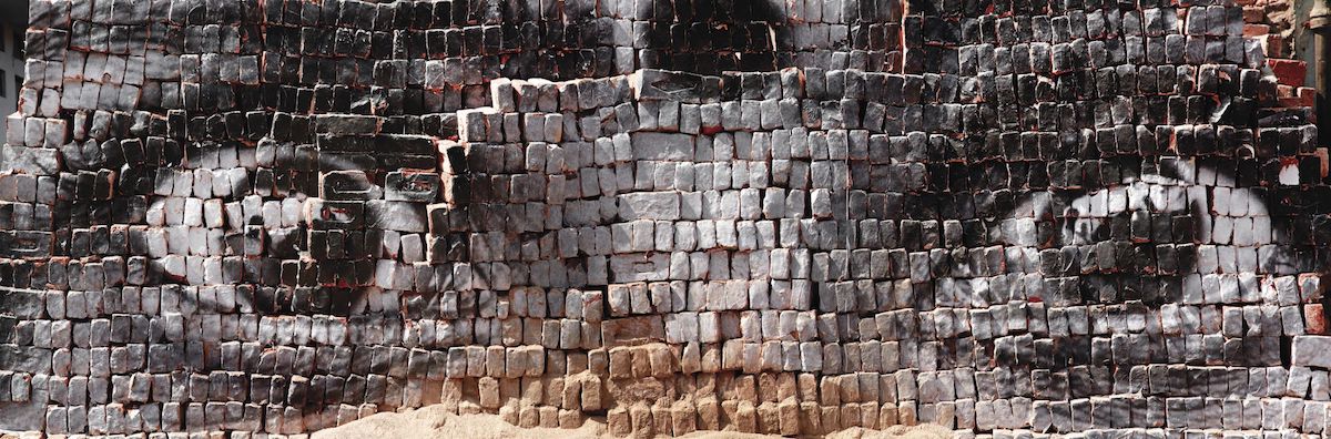 Photo of a woman's eyes on bricks for Women Are Heroes Project