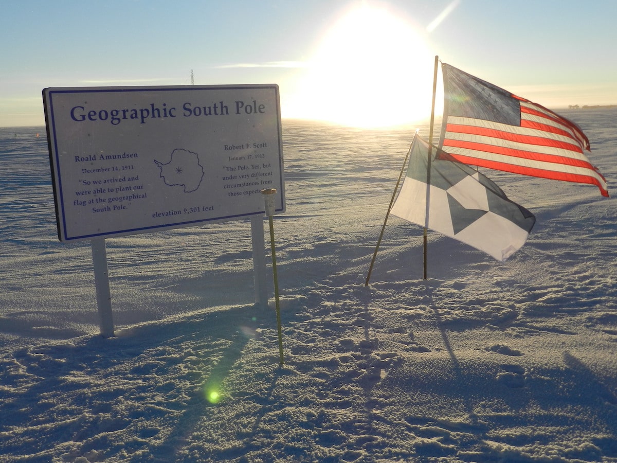 True South and the American flag at the Geographic South Pole