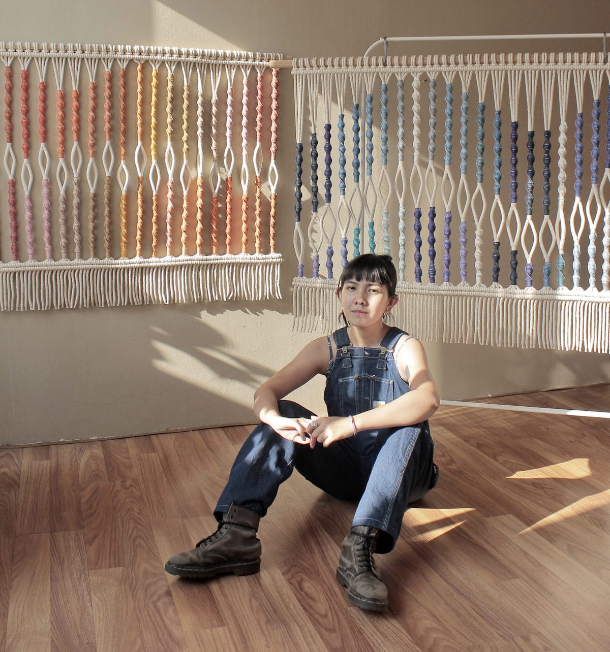 Artist Agnes Hansella Sitting In Front of Her Macrame Work