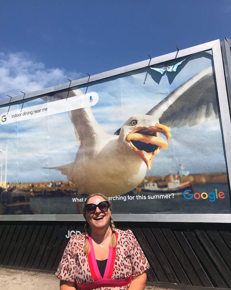 Hannah Huxford Standing in Front of Her Photo on Google Ad