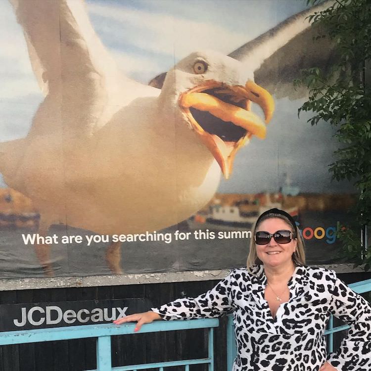 Hannah Huxford Standing in Front of Her Photo on Google Ad
