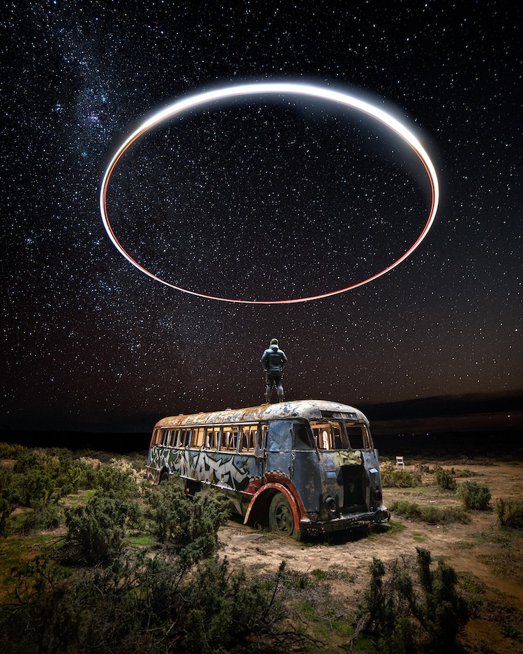 Man Standing on Abandoned Bus at Night with Circular Light Painting Above His Head