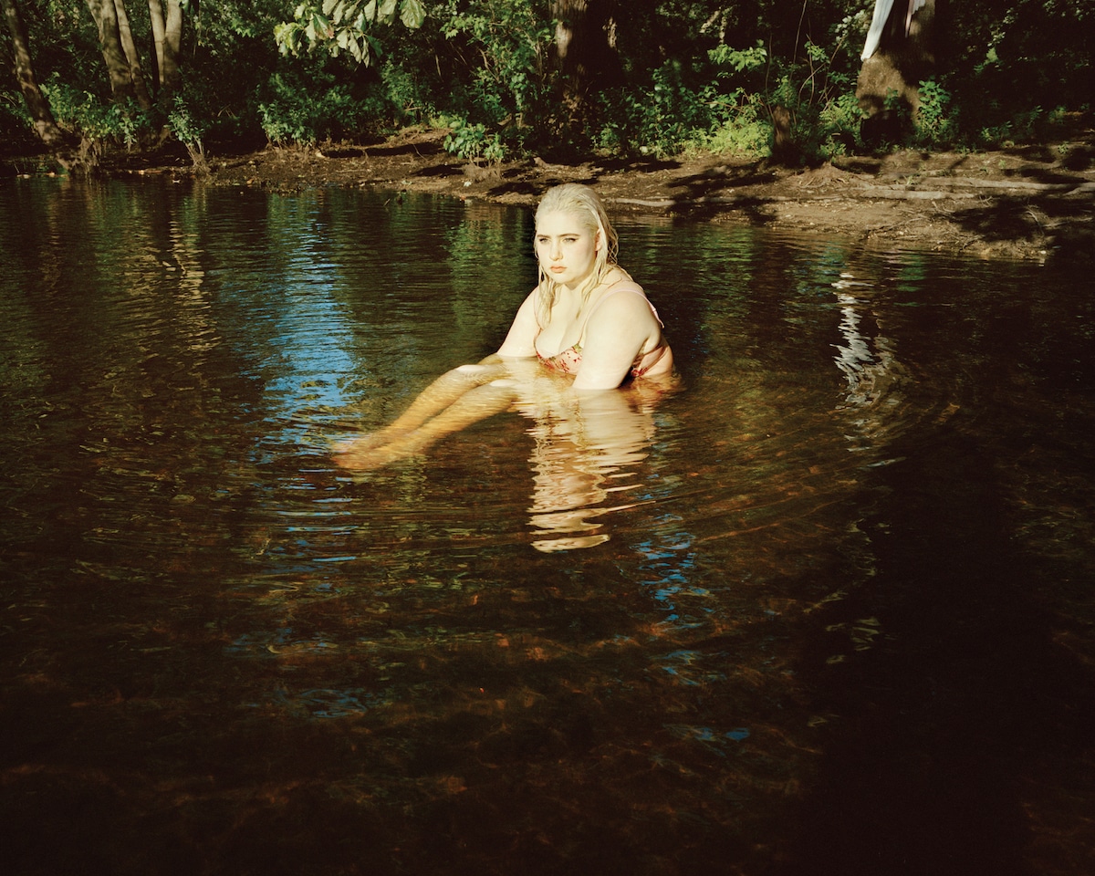 Young Woman Sitting in Shallow Water