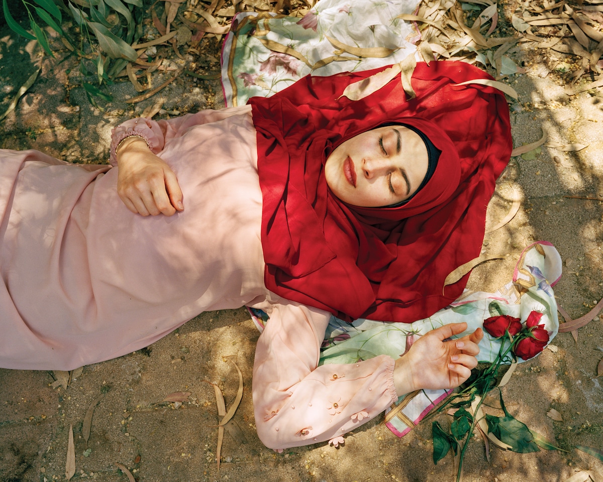 Woman with Red Headscarf Laying on the Ground