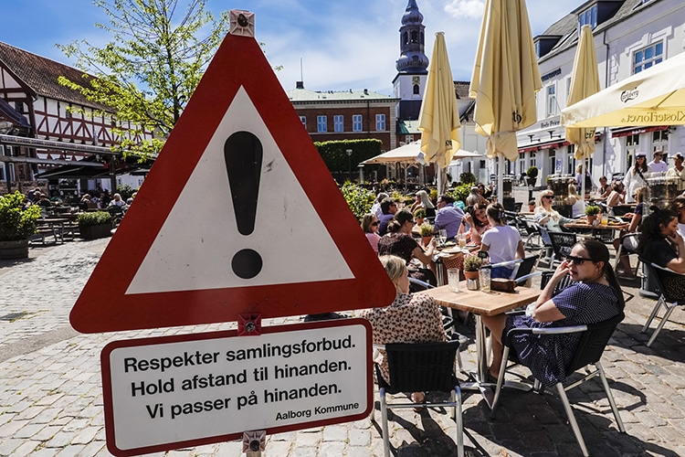 A sign in Aalborg, Denmark advertises social distancing measures.
