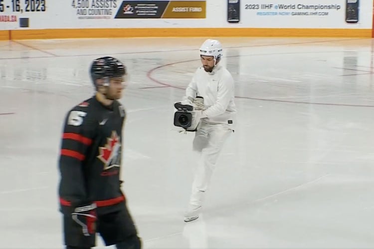 Camouflaged Camera Man Becomes a Fan Favorite at Hockey Tournament