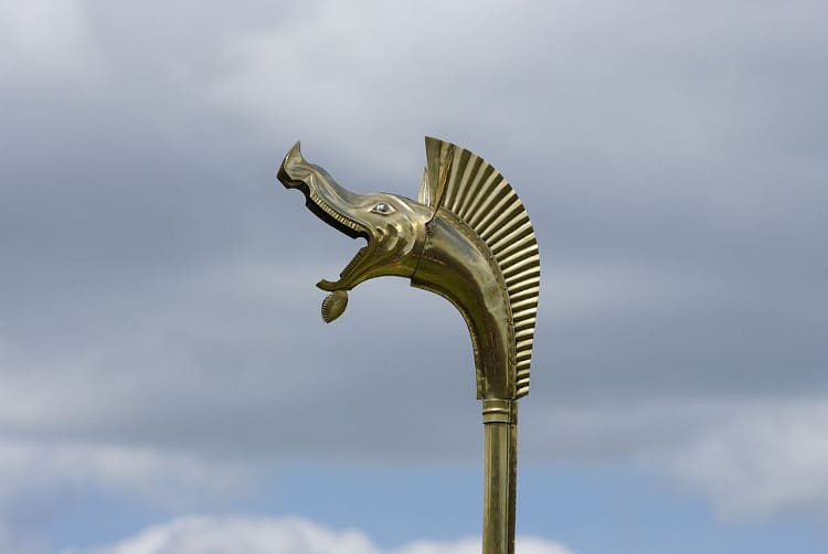 Golden Celtic Carnyx in front of a sky background