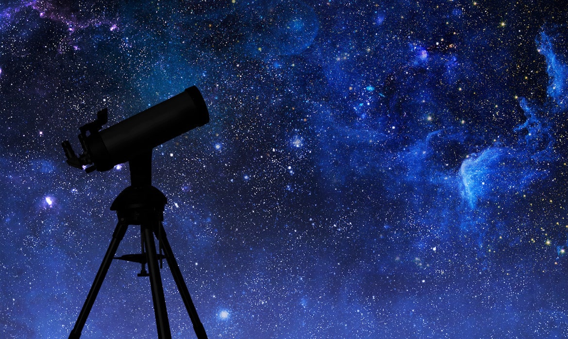 Telescope under a starry night sky