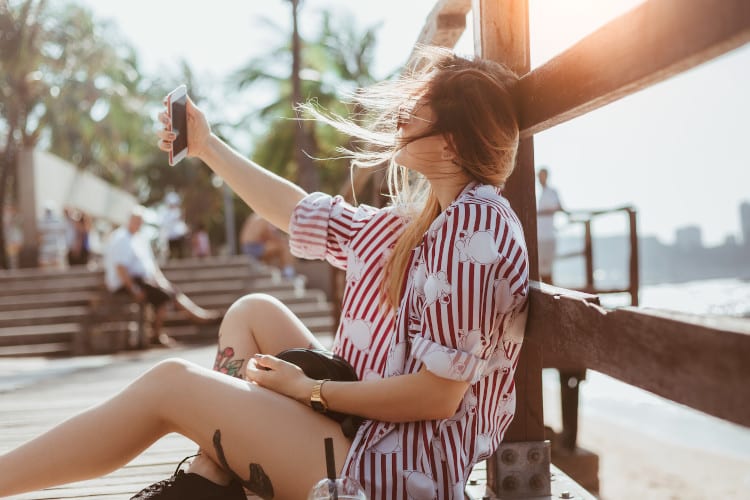 Woman taking selfie on boardwalk