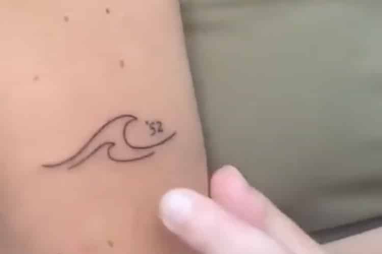 Screenshots of video showing a daughter presenting her Alzheimer's tattoo following her dad's diagnosis