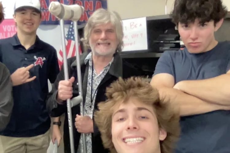 Teacher Clayton Guy poses with students who crated a fundraiser for his wife