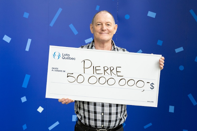 Pierre Richer holding novelty check