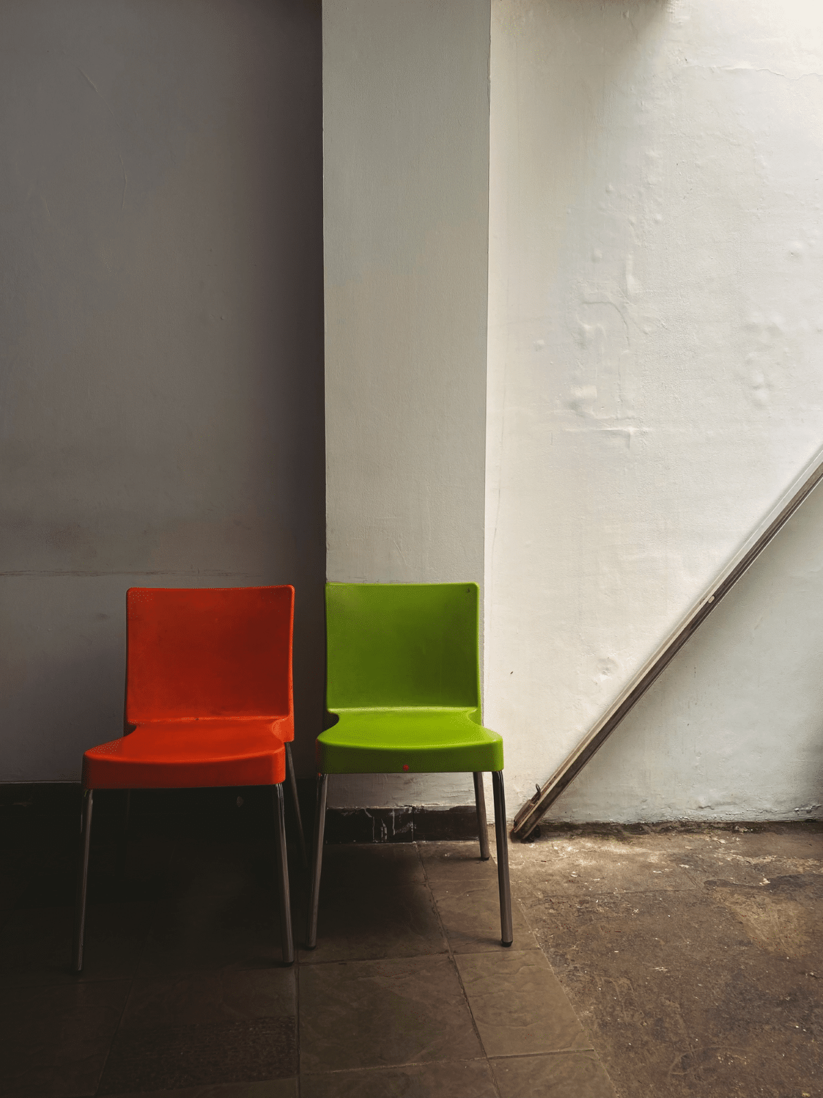 A red and a green chair in a waiting room
