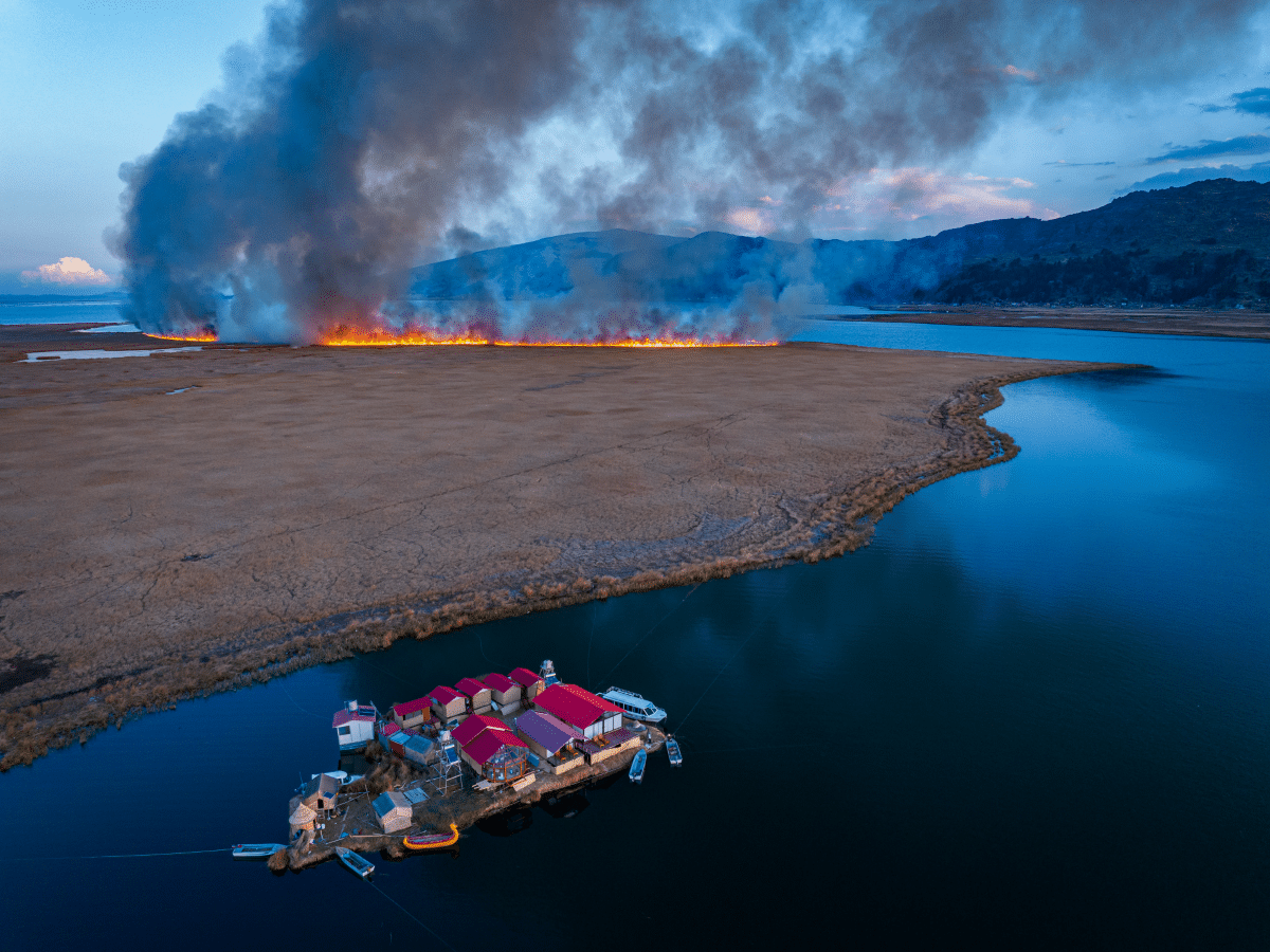 Floating village on -lake Titicaca with wildfire in the background